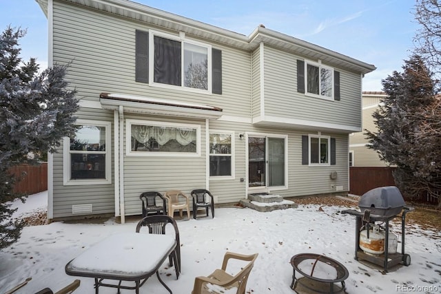 view of snow covered rear of property