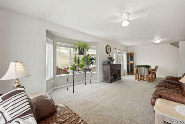 carpeted living room with ceiling fan