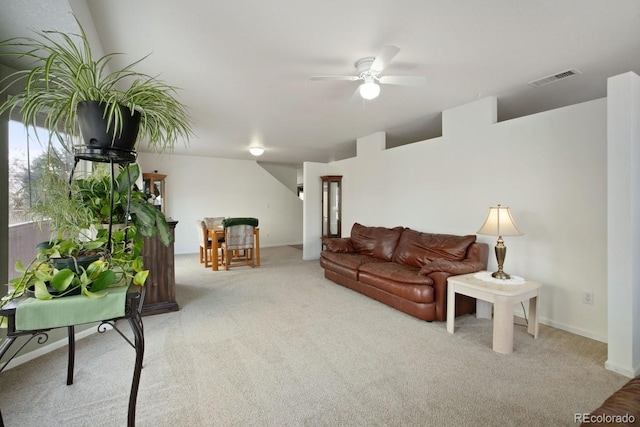 carpeted living room featuring ceiling fan