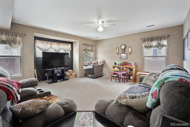 carpeted living room with ceiling fan