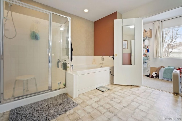 bathroom with separate shower and tub