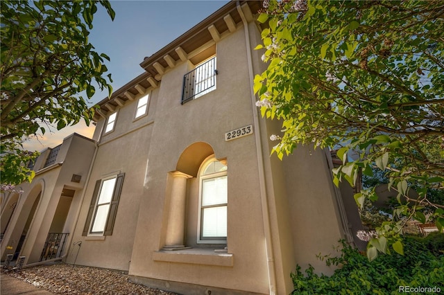 view of side of property featuring stucco siding