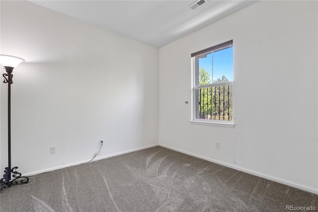 carpeted empty room with baseboards