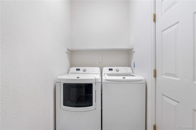 washroom with washing machine and clothes dryer