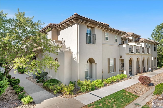mediterranean / spanish home with stucco siding and a balcony