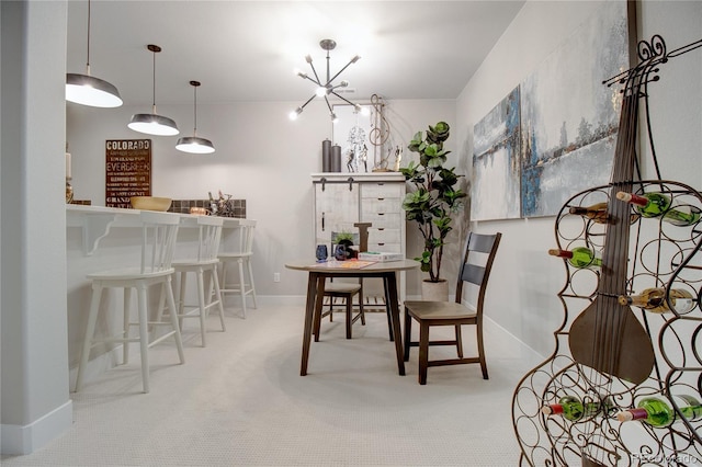 carpeted dining room with an inviting chandelier