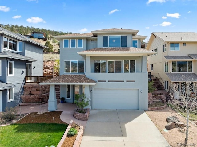643 1st Ave, Lyons, CO 80540 - view of front of property with an attached garage, concrete driveway, stucco siding, and stairway