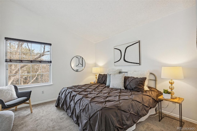 bedroom featuring vaulted ceiling, carpet, and a textured ceiling