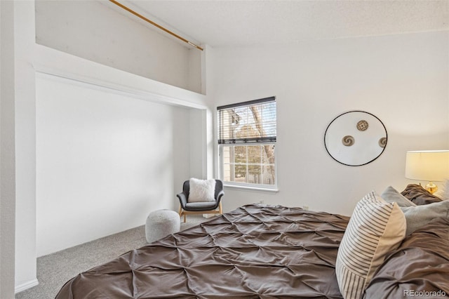 bedroom featuring lofted ceiling and carpet floors