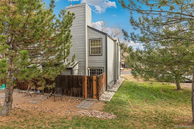 view of property exterior featuring a lawn