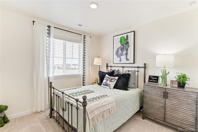 22323 E 6th Pl, Aurora, CO 80018 - bedroom with visible vents, baseboards, and light carpet