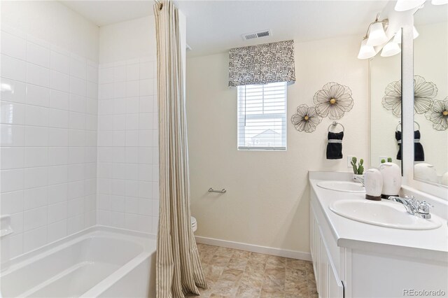 22323 E 6th Pl, Aurora, CO 80018 - full bath with shower / bath combo with shower curtain, a sink, visible vents, and baseboards