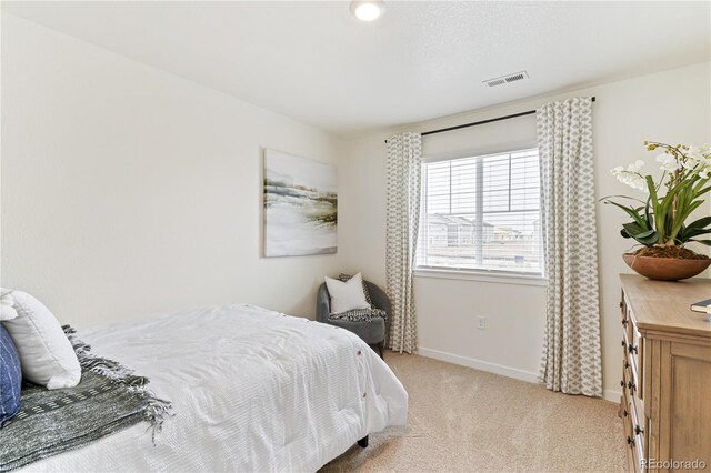 22323 E 6th Pl, Aurora, CO 80018 - bedroom with baseboards, visible vents, and light colored carpet