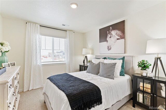 22323 E 6th Pl, Aurora, CO 80018 - bedroom featuring light carpet, visible vents, and baseboards
