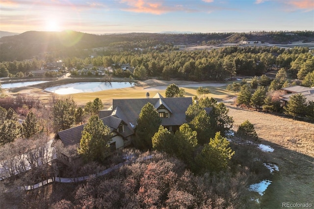 aerial view with a wooded view and a water view