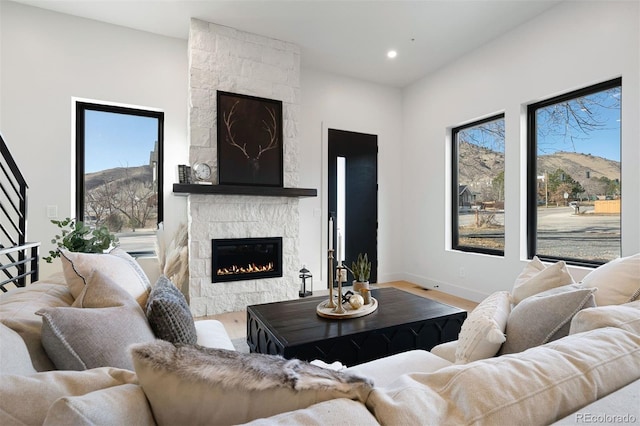 living room with a mountain view, a large fireplace, and hardwood / wood-style flooring