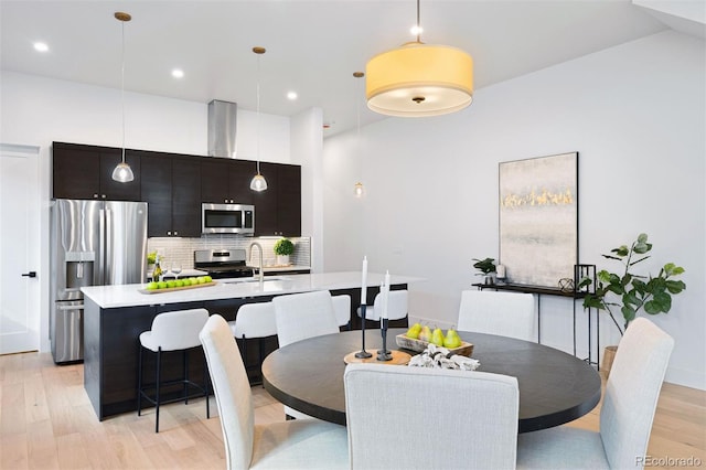 dining room with sink and light hardwood / wood-style floors