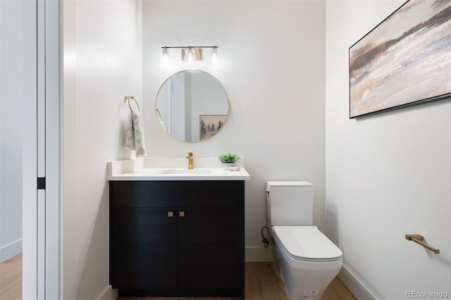 bathroom featuring hardwood / wood-style floors, vanity, and toilet