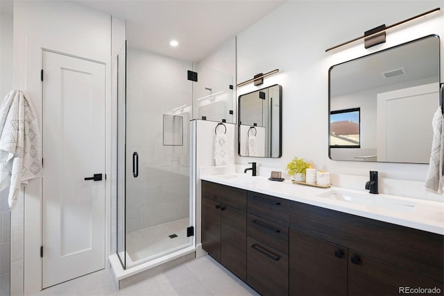 bathroom featuring vanity, tile patterned floors, and a shower with door