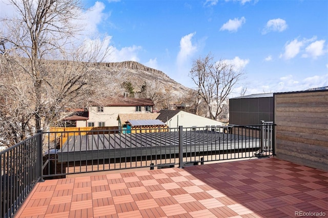 wooden deck with a mountain view