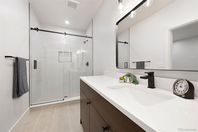 bathroom with vanity, tile patterned floors, and an enclosed shower