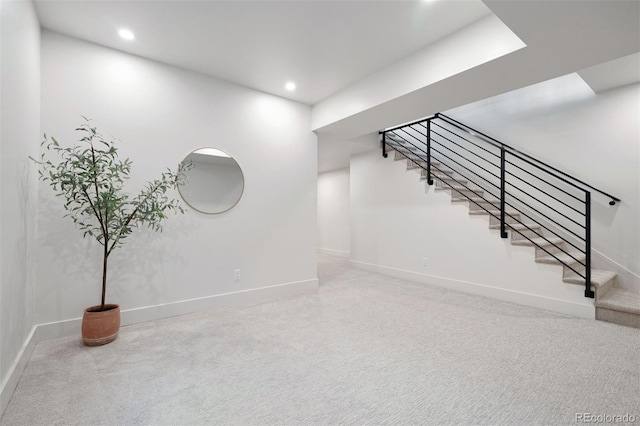 interior space featuring baseboards, stairway, and recessed lighting