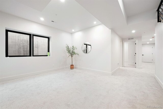 spare room featuring recessed lighting, visible vents, light carpet, and baseboards