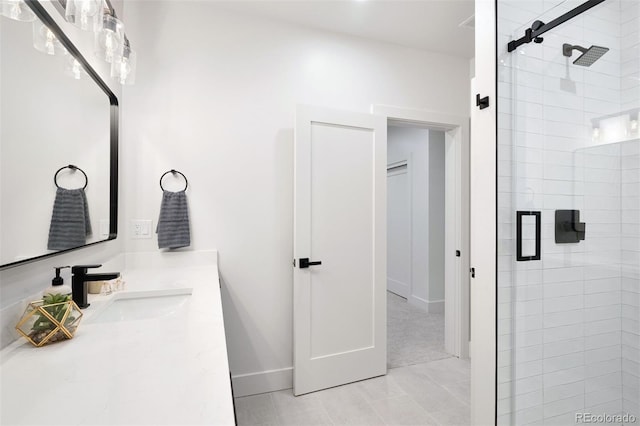 bathroom with a shower stall, vanity, and baseboards