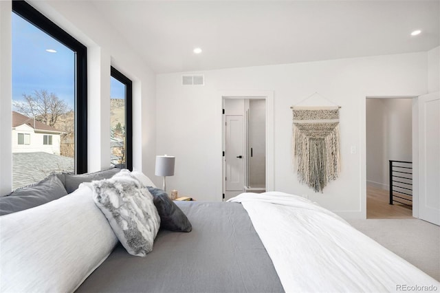 bedroom with light colored carpet, recessed lighting, and visible vents