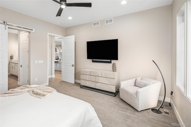bedroom featuring recessed lighting, baseboards, visible vents, and a barn door
