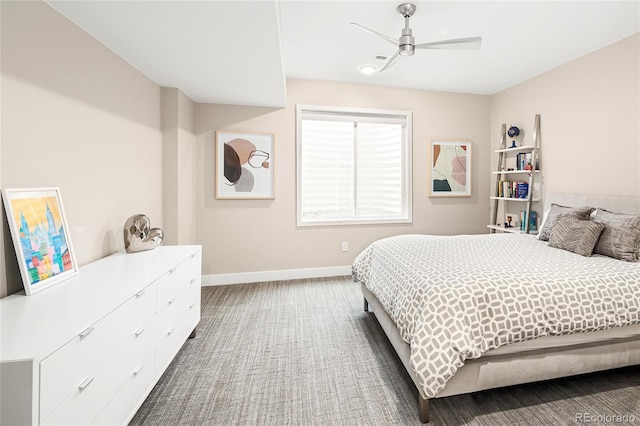 bedroom with ceiling fan, baseboards, and carpet