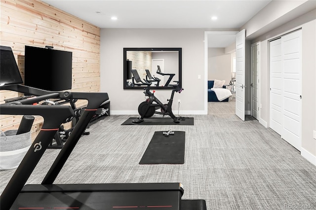 workout room with wooden walls, baseboards, recessed lighting, and carpet