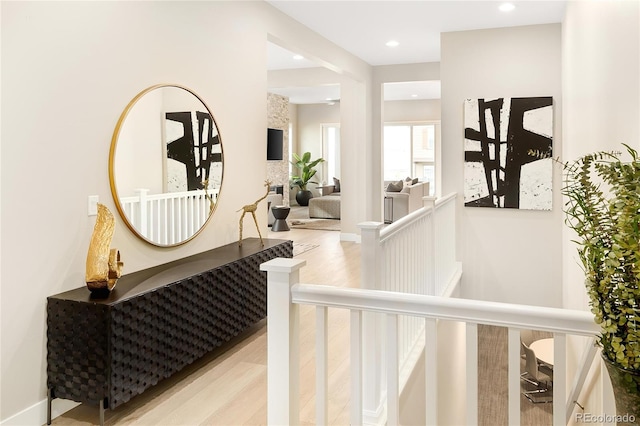 stairs with recessed lighting and wood finished floors