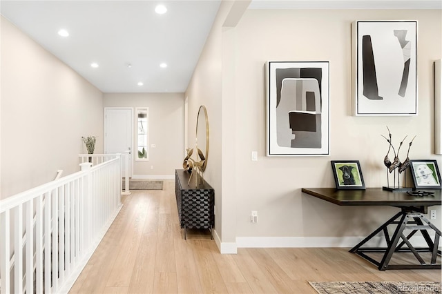 hallway featuring light wood-type flooring, baseboards, and recessed lighting