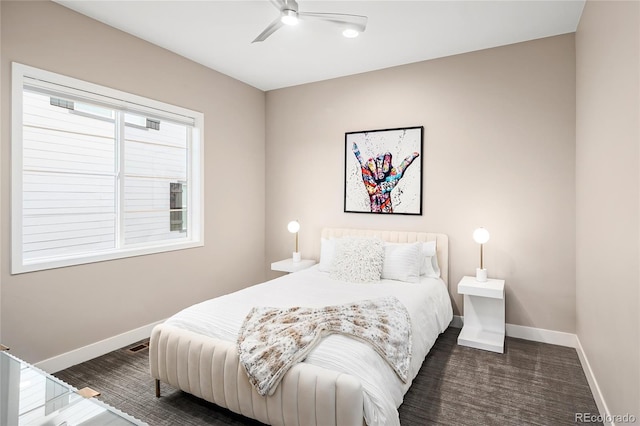 bedroom featuring wood finished floors, baseboards, and a ceiling fan
