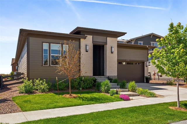 6530 Barnstead Dr, Castle Pines, CO 80108 - view of front of home featuring asphalt driveway, an attached garage, and brick siding