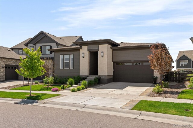 6530 Barnstead Dr, Castle Pines, CO 80108 - view of front of house featuring a garage and concrete driveway