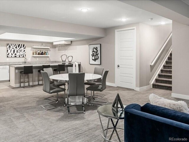6530 Barnstead Dr, Castle Pines, CO 80108 - dining area with bar with sink, stairs, light carpet, and recessed lighting