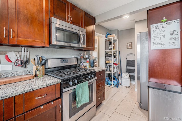 3640 N Saint Paul St, Denver, CO 80205 - kitchen with appliances with stainless steel finishes, light stone countertops, light tile patterned floors, and recessed lighting