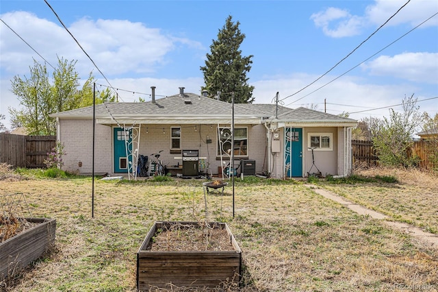3640 N Saint Paul St, Denver, CO 80205 - rear view of property featuring a vegetable garden, a fenced backyard, and a fire pit