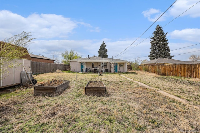 3640 N Saint Paul St, Denver, CO 80205 - rear view of house with a garden and a fenced backyard