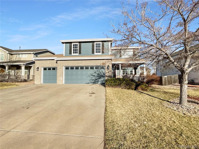 traditional-style house featuring an attached garage, a porch, concrete driveway, and a front yard