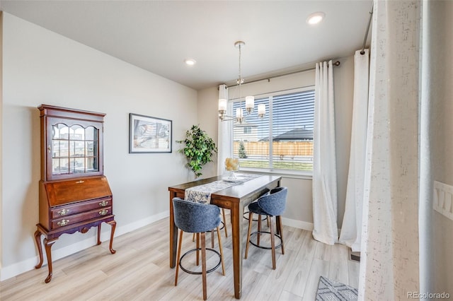 dining room with baseboards, recessed lighting, and light wood-style flooring