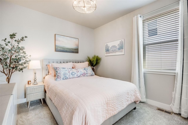 bedroom with carpet floors, baseboards, and visible vents