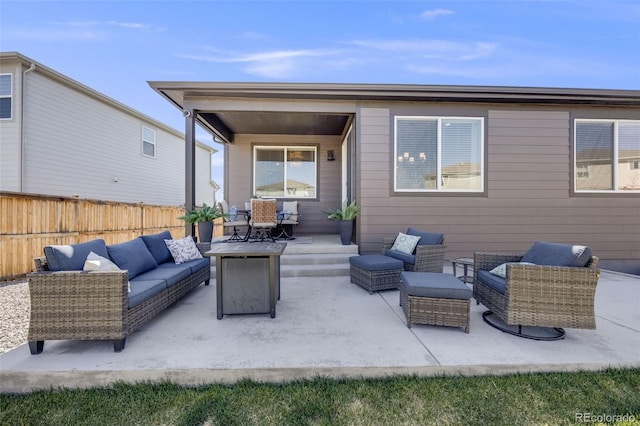 rear view of property with fence, an outdoor living space, and a patio