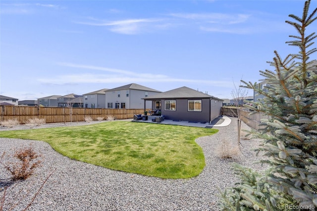 back of property featuring a fenced backyard, an outdoor hangout area, a patio area, a lawn, and a residential view