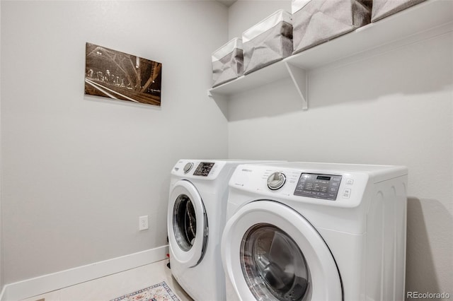 laundry room with baseboards, laundry area, and washer and clothes dryer