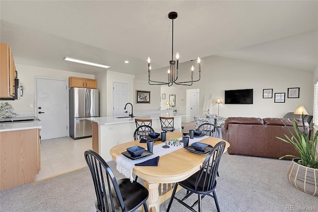 dining space with light carpet, light tile patterned floors, and vaulted ceiling