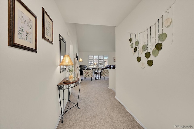 hallway with light carpet and baseboards