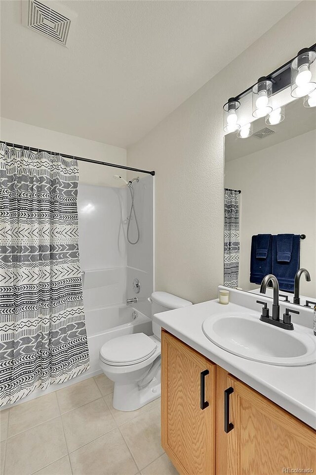 bathroom featuring toilet, vanity, tile patterned flooring, and visible vents